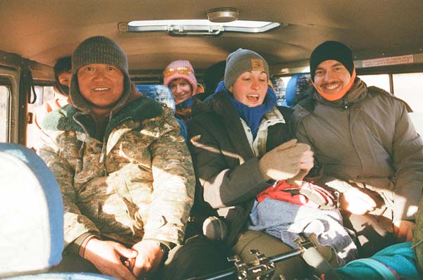 People sitting on the back seats of a minibus
