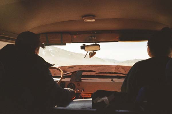 Silhouettes of two people in a minibus as driver and passenger