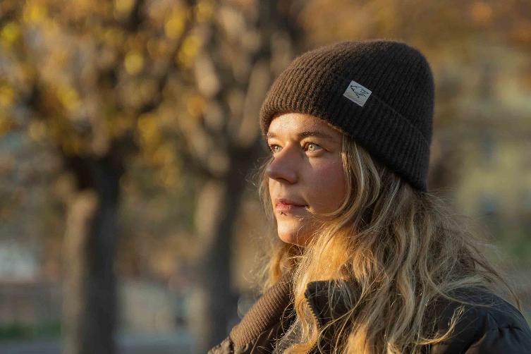 Blonde-haired woman with dark brown woollen hat