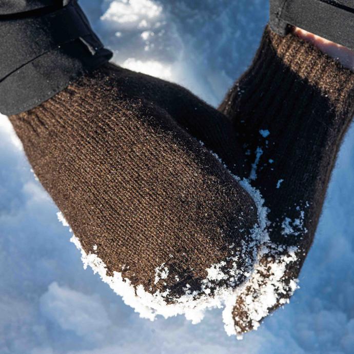 Mittens made from dark yak wool form a snowball